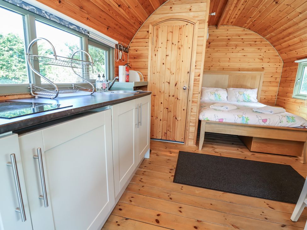 A studio with a kitchen area and a bed at Gayton Stables in Heswall