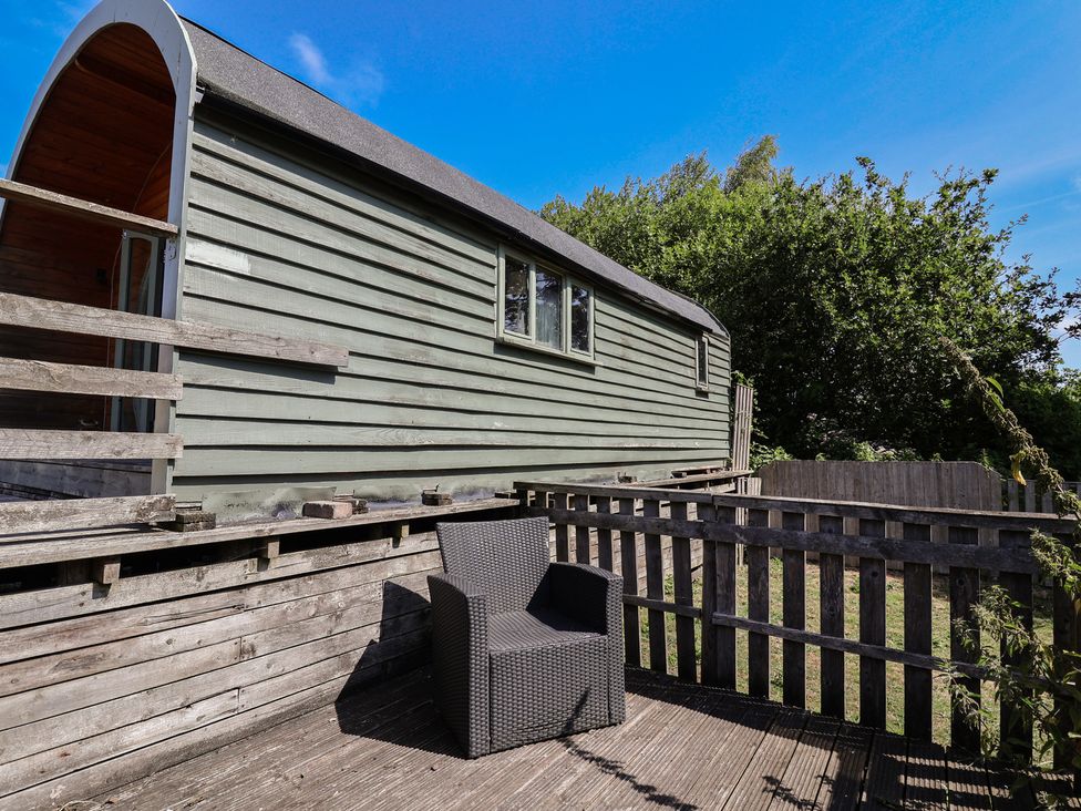 A building with a chair on a deck at Gayton Stables in Heswall