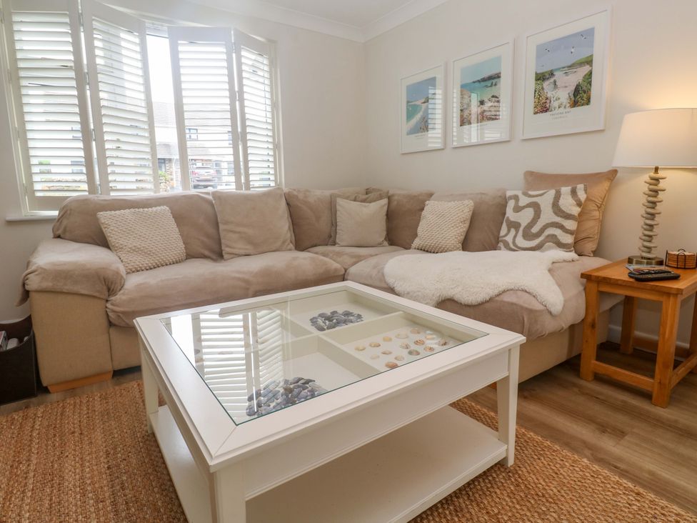A living room with a sofa and coffee table at Trelowen St Issey near Padstow