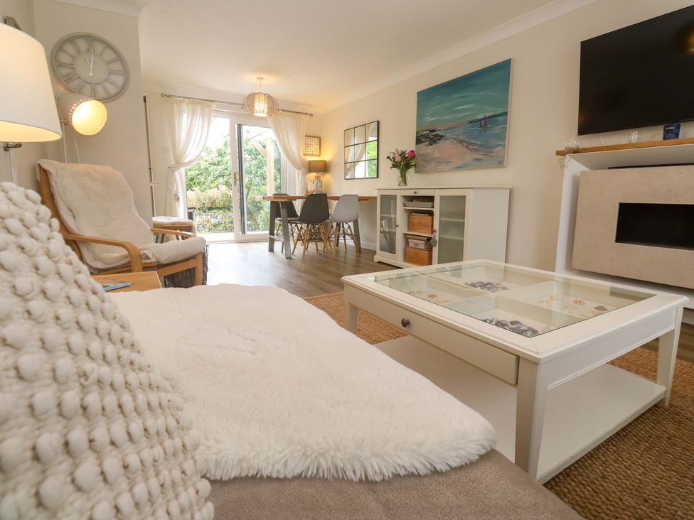 A living room with a coffee table and dining area at Trelowen St Issey near Padstow