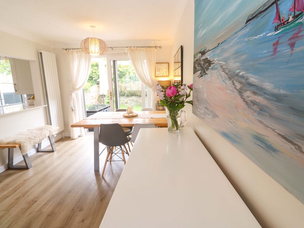 A dining room with a wooden table and chairs at Trelowen St Issey near Padstow