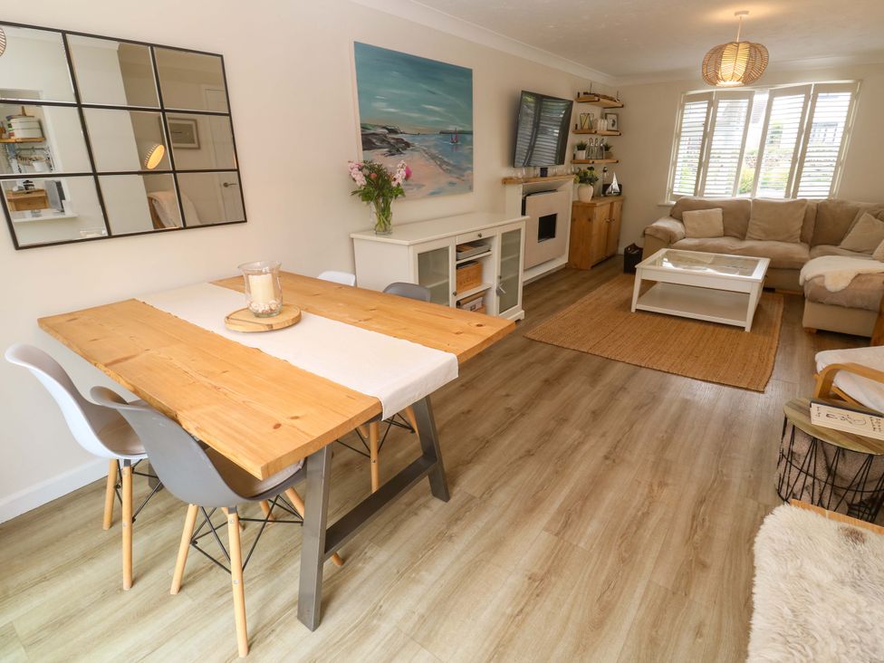 A living room with a dining table and chairs at Trelowen St Issey near Padstow
