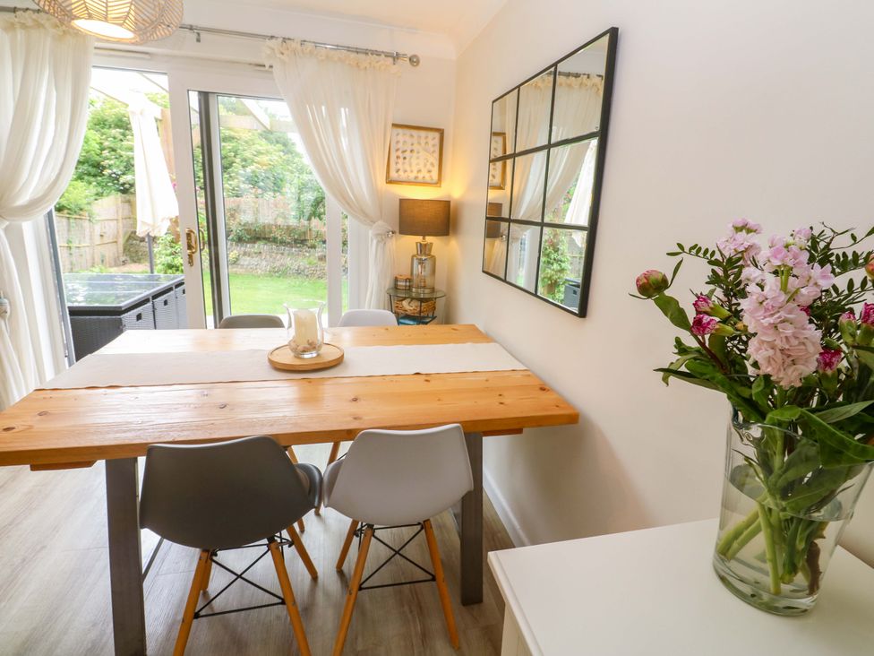 A dining room with a table and chairs at Trelowen in St Issey near Padstow