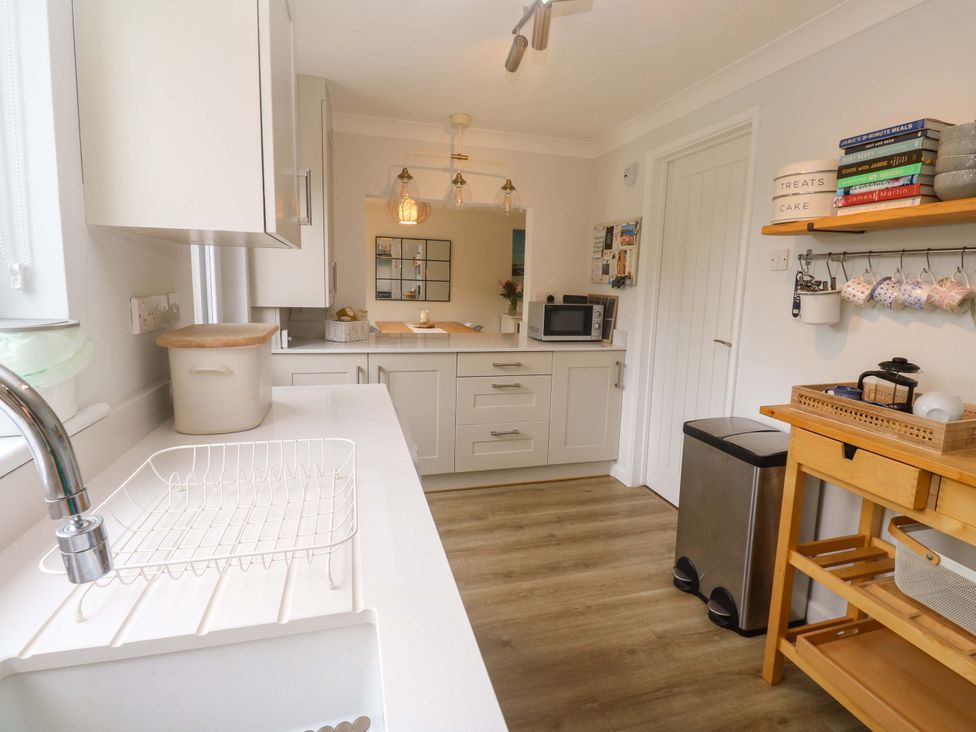 A kitchen with a sink and cabinets at Trelowen St Issey near Padstow