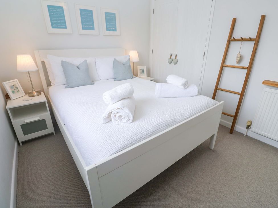 A bedroom with a bed and bedside table at Trelowen in St Issey near Padstow
