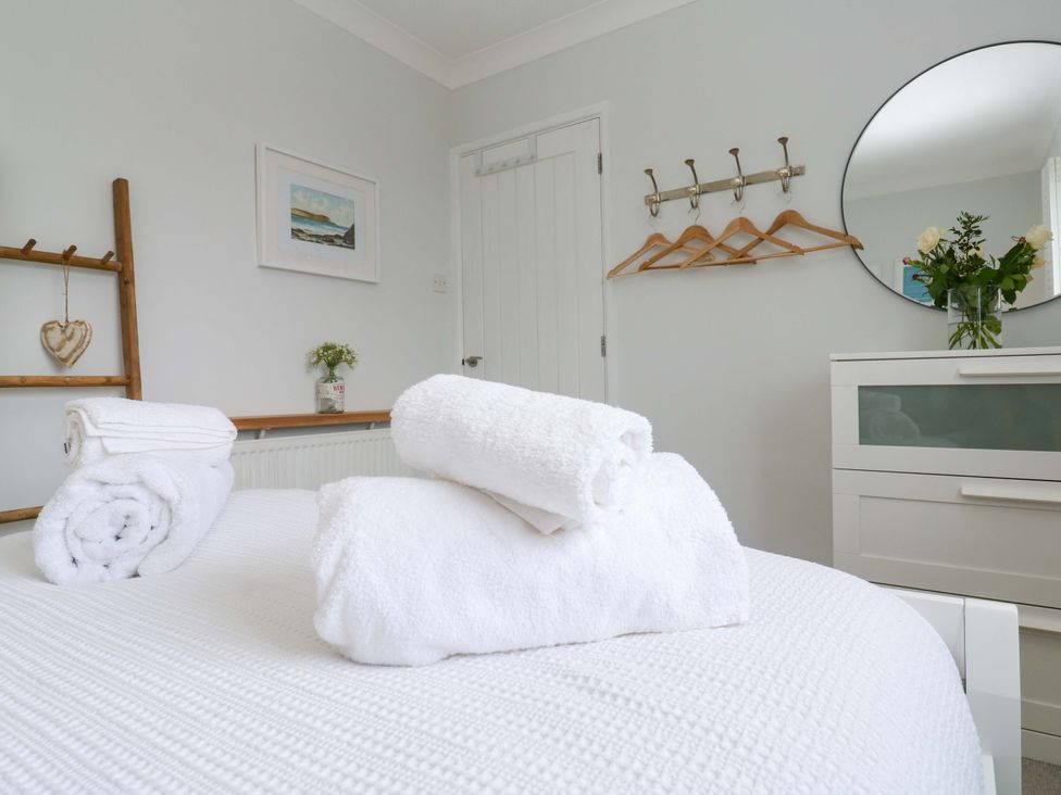 A bedroom with towels on a bed at Trelowen St Issey near Padstow