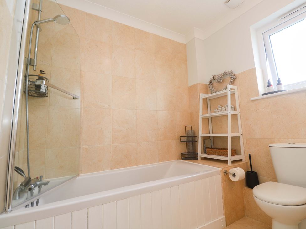 A bathroom with a bathtub and toilet at Trelowen St Issey near Padstow