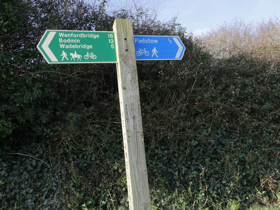 A signpost indicating directions and distances to nearby locations at Trelowen St Issey near Padstow