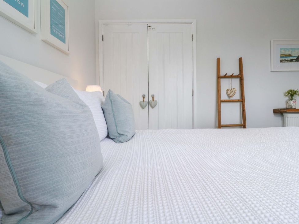 A bedroom with a bed and wardrobe at Trelowen St Issey near Padstow