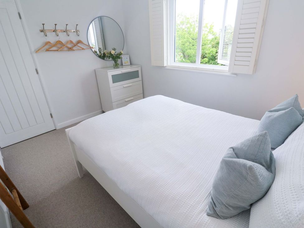 A bedroom with a bed and dresser at Trelowen St Issey near Padstow