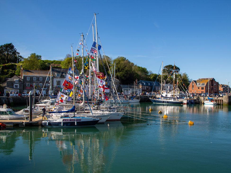 A harbor with sailboats and flags at Trelowen St Issey near Padstow