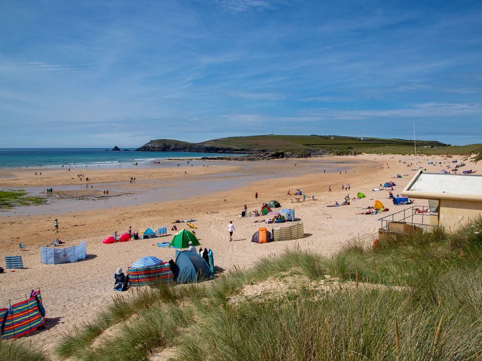 A beach with people and tents at Trelowen St Issey near Padstow