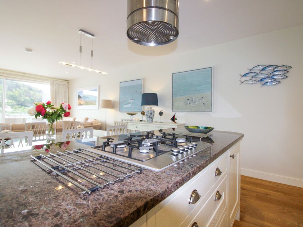 A kitchen with a gas stove and dining area at Villa 1, Estura in Salcombe