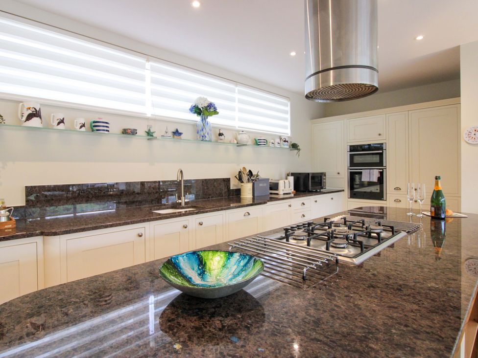 A kitchen with a cooking stove and sink at Villa 1, Estura Salcombe