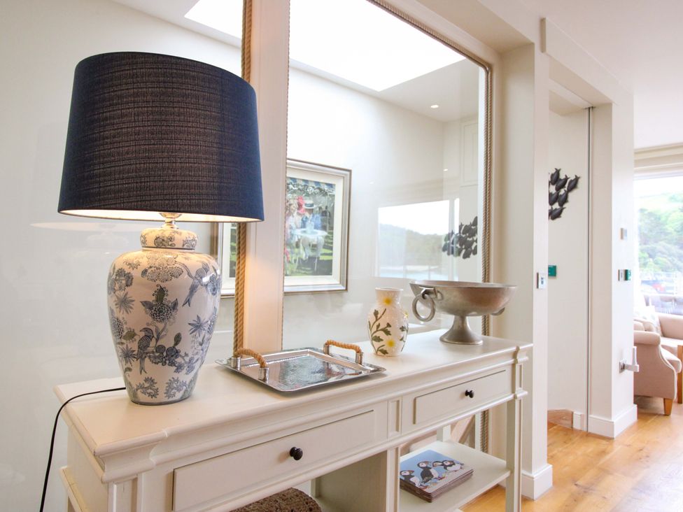 A living room with a lamp and decorative items at Villa 1, Estura, Salcombe