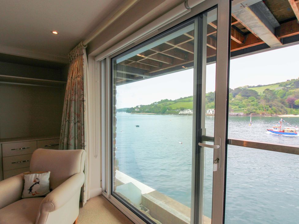A living room with a view of the water and a boat at Villa 1, Estura, Salcombe
