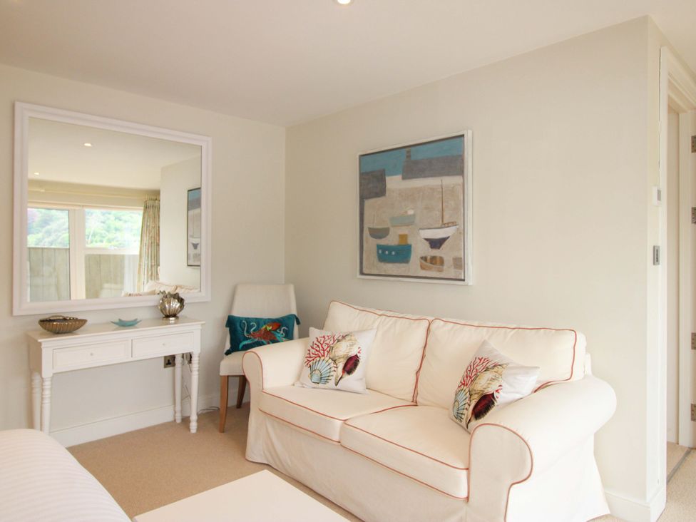 A living room with a sofa and table at Villa 1, Estura in Salcombe