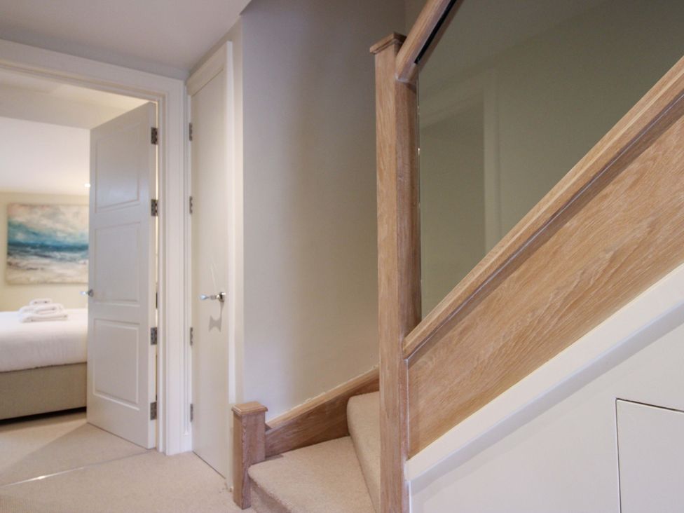 A staircase leading to upstairs rooms at Villa 1, Estura in Salcombe