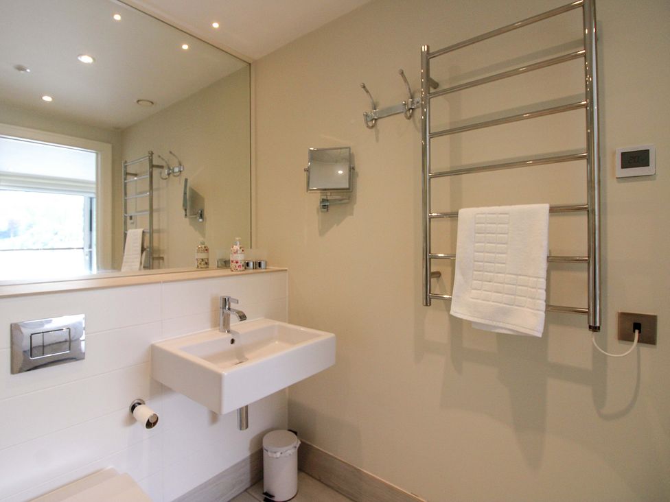 A bathroom with a sink, toilet, and towel rail at Villa 1, Estura in Salcombe