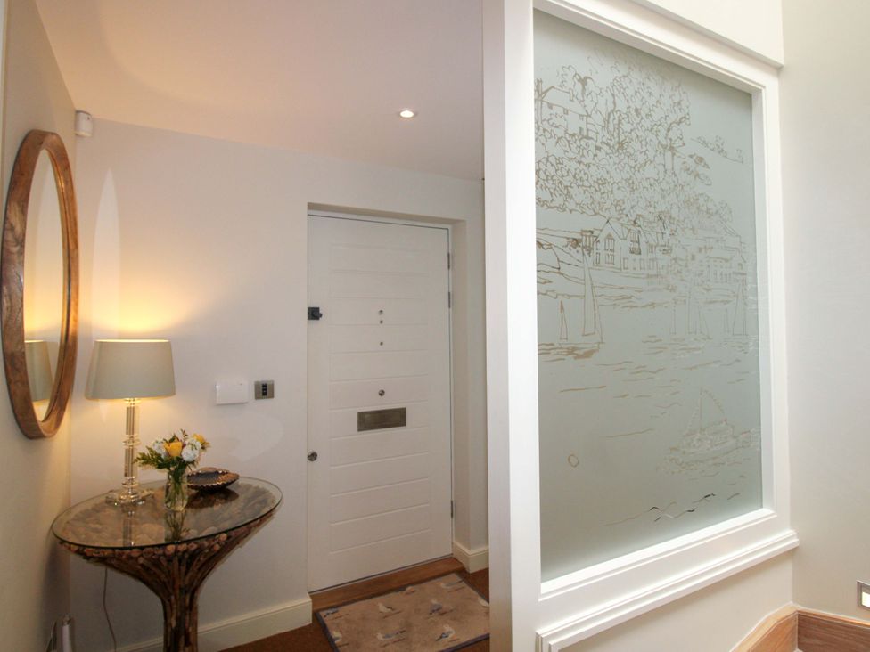 A hallway with a console table and lamp at Villa 1, Estura, Salcombe