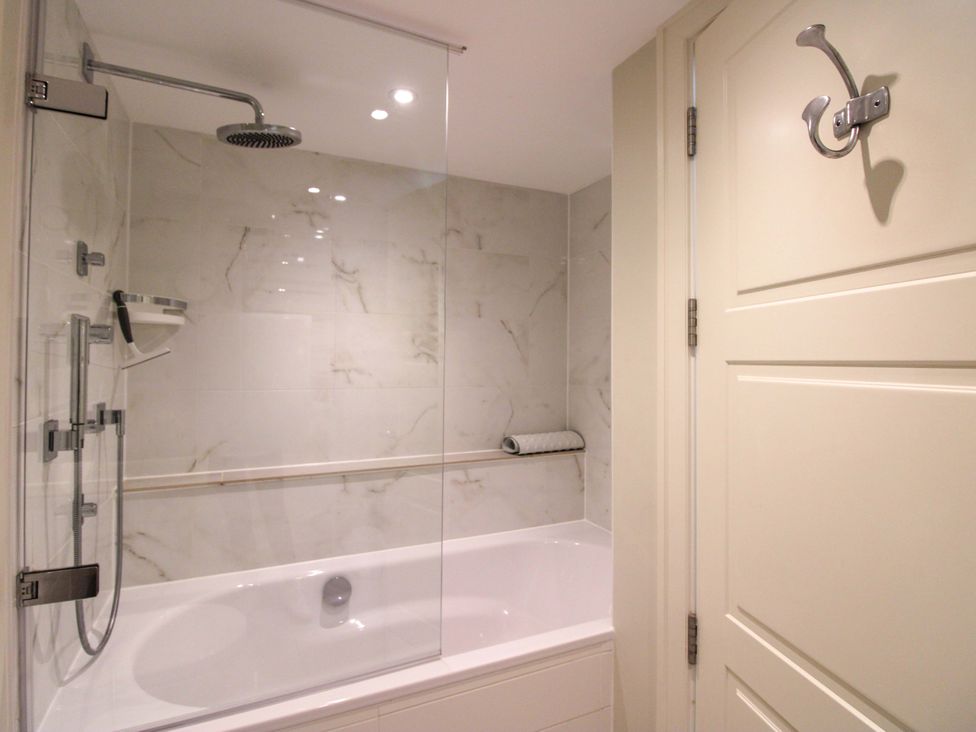 A bathroom with a shower and bathtub at Villa 1, Estura in Salcombe