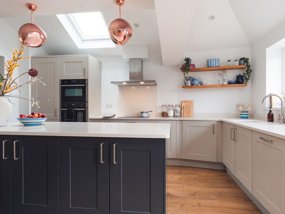 A kitchen with cabinets and countertop at Gerallt in Morfa Nefyn