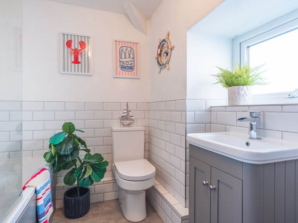A bathroom with a toilet and sink at Gerallt in Morfa Nefyn