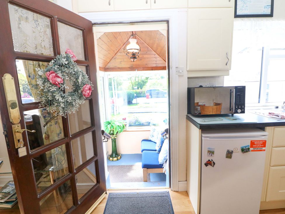 A kitchen with a microwave and fridge at Waterfall House Dunmanway, County Cork