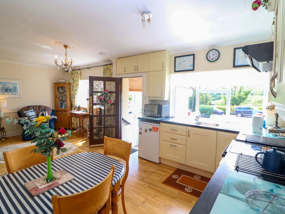 A kitchen with a table and chairs at Waterfall House in Dunmanway, County Cork