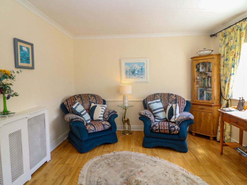 A living room with two sofas and a lamp at Waterfall House in Dunmanway, County Cork