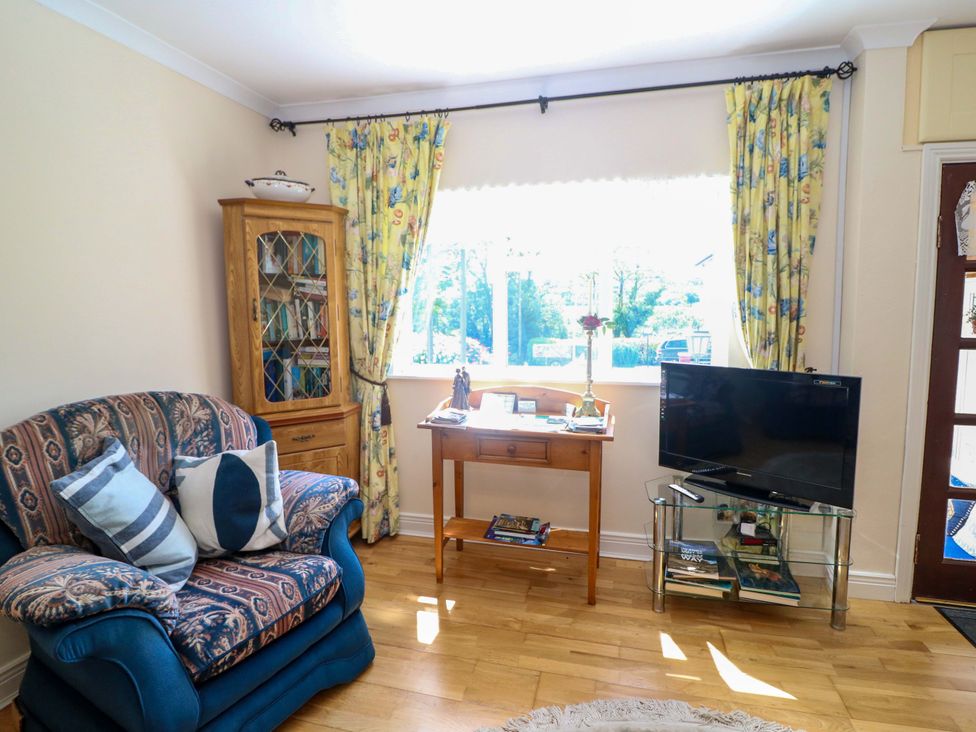 A living room with a sofa and television at Waterfall House Dunmanway County Cork