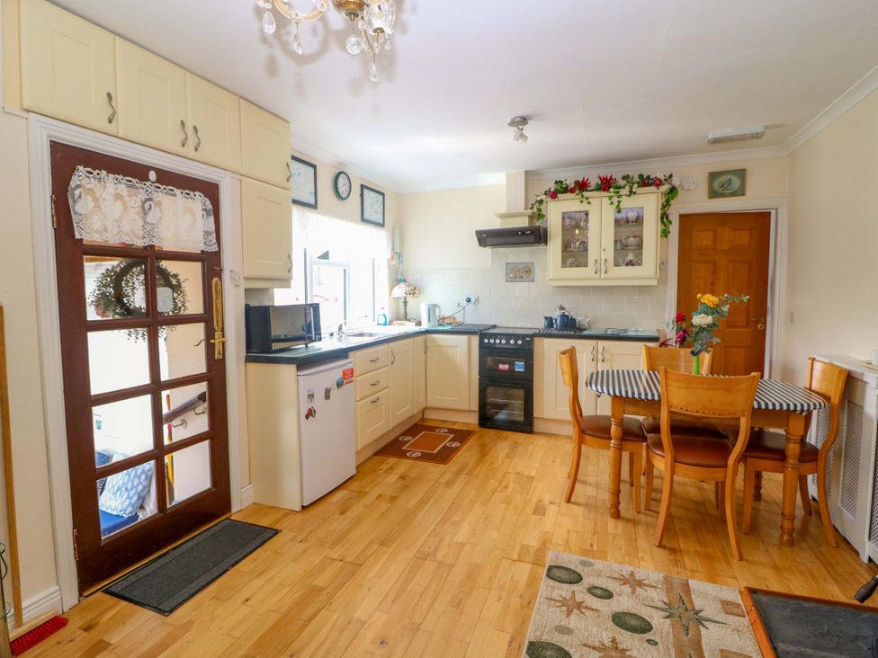 A kitchen with a table and chairs at Waterfall House in Dunmanway, County Cork