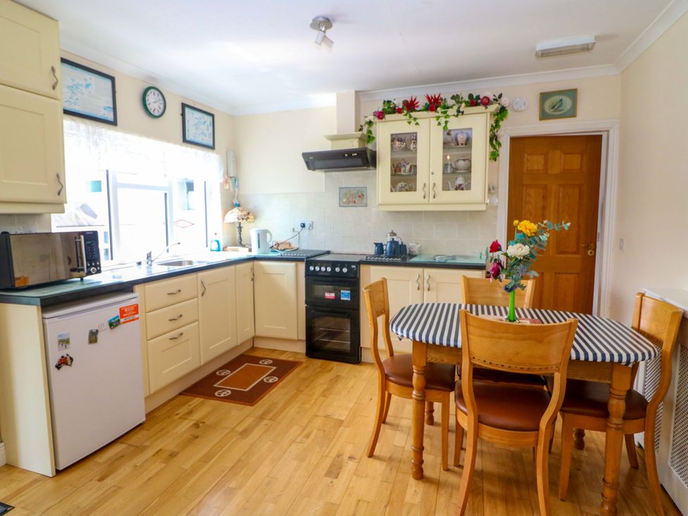 A kitchen with a table and chairs at Waterfall House in Dunmanway, County Cork