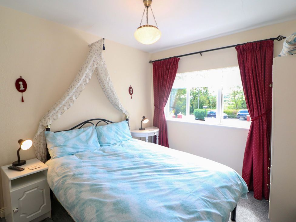 A bedroom with a bed and window at Waterfall House in Dunmanway, County Cork