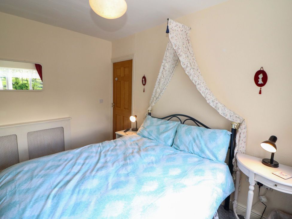 A bedroom with a bed and a bedside table at Waterfall House, Dunmanway, County Cork