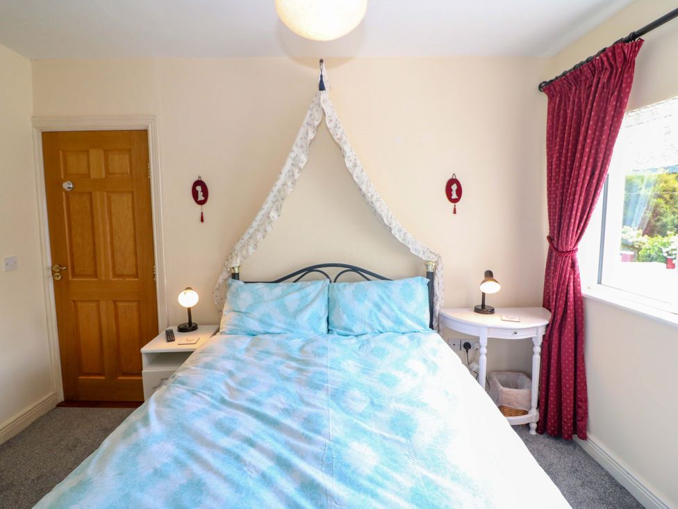 A bedroom with a bed and bedside tables at Waterfall House in Dunmanway, County Cork