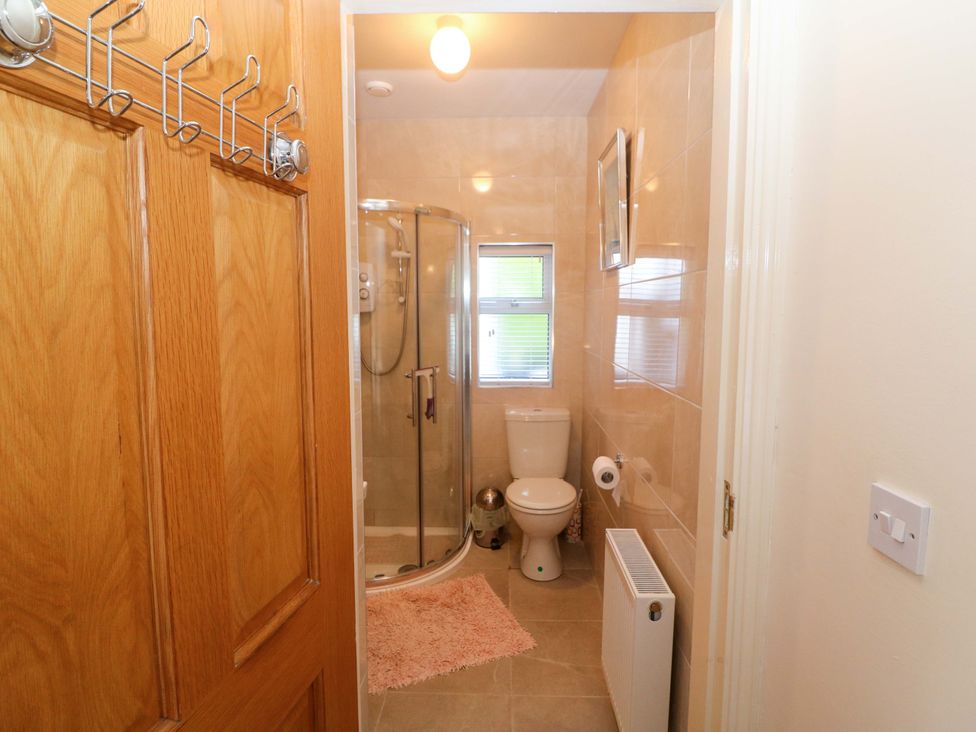 A bathroom with a shower, toilet, and sink at Waterfall House, Dunmanway, County Cork