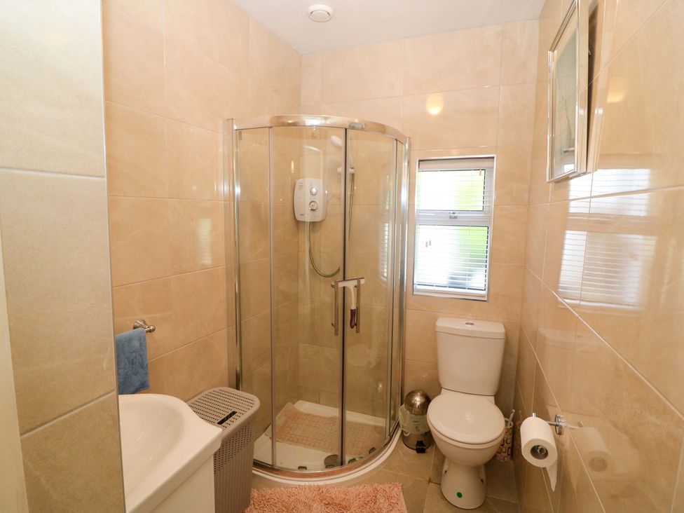 A bathroom with shower, toilet, and sink at Waterfall House in Dunmanway, County Cork