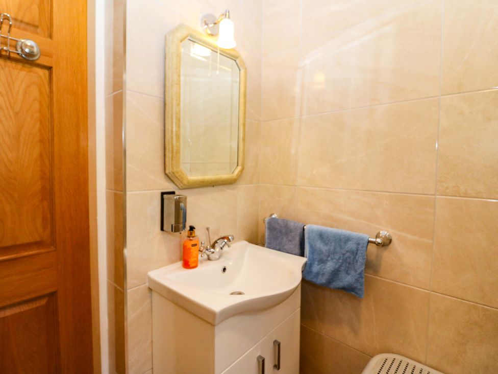 A bathroom with a sink and mirror at Waterfall House in Dunmanway, County Cork