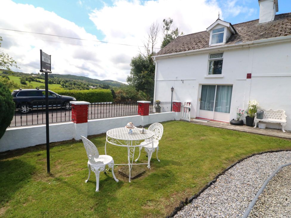 A garden with a table and chairs at Waterfall House, Dunmanway, County Cork