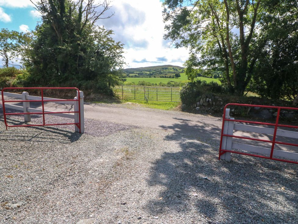 A view of a gravel road with gates leading to fields at Waterfall House in Dunmanway, County Cork