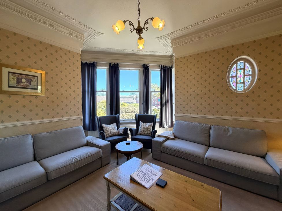 A living room with seating arrangements and a coffee table at Ryburn Lodge in Bridlington