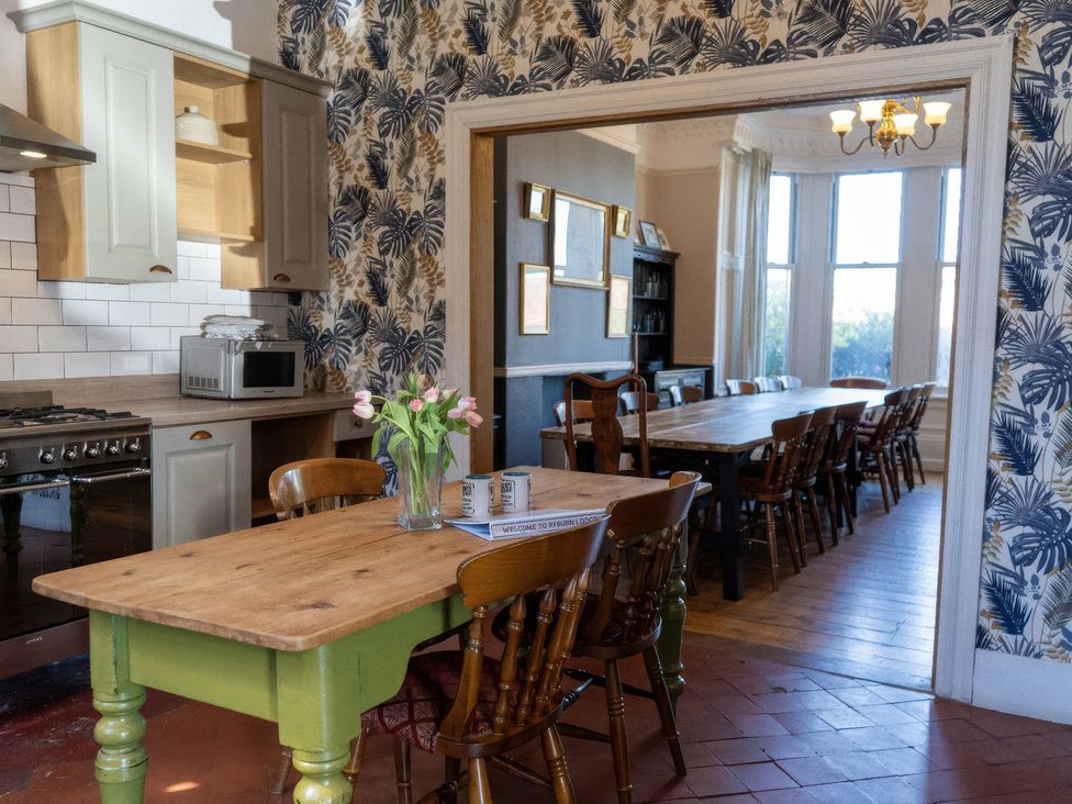 A kitchen with a table and chairs along with a dining area at Ryburn Lodge Bridlington