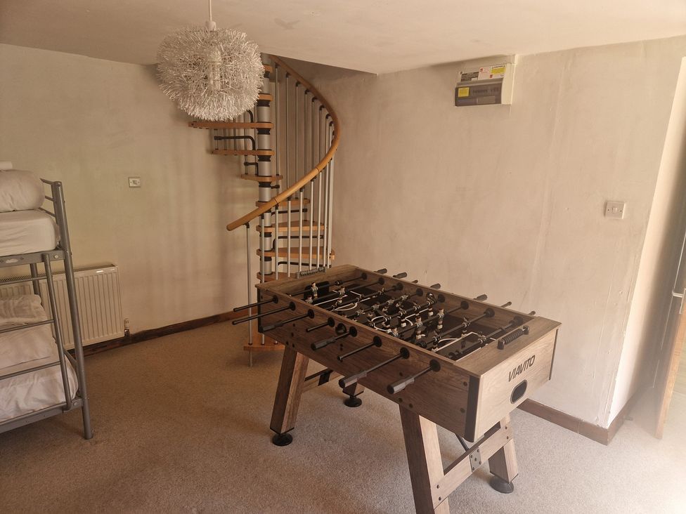A game room with a foosball table and a bunk bed at Pennant Tigi Uchaf in Dinas Mawddwy