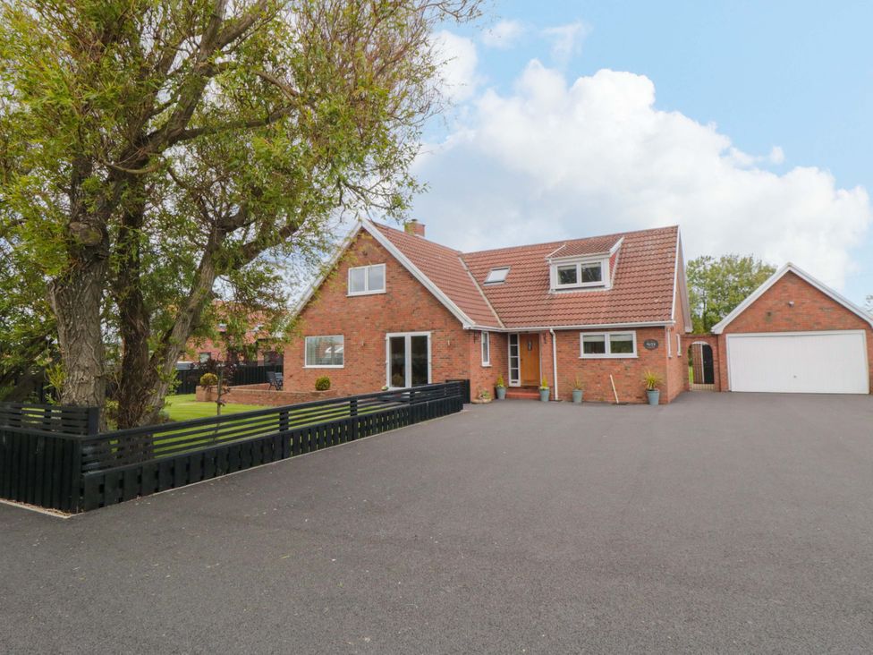 A house with a garage and driveway at Wyvill House in Cayton