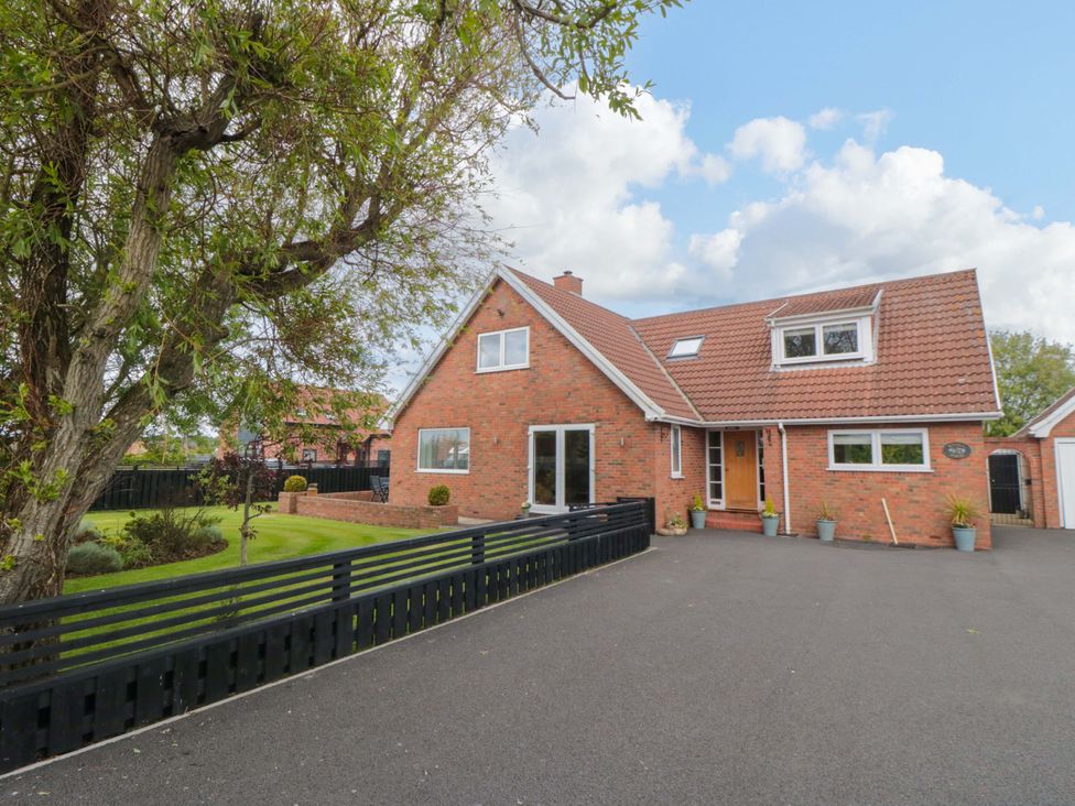 A house with a front garden and driveway at Wyvill House in Cayton
