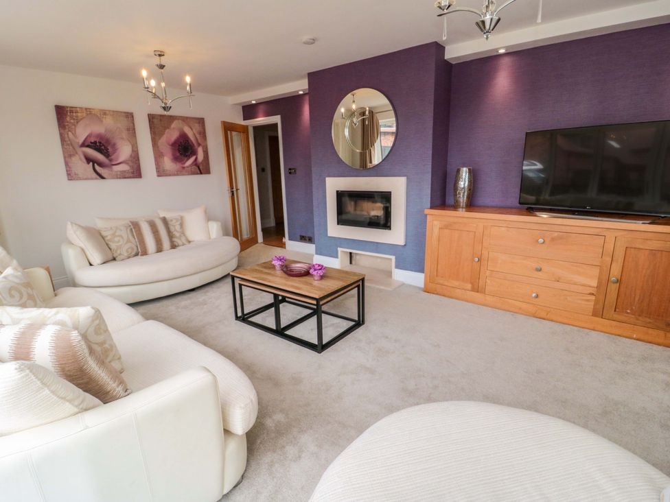 A living room with sofa and television at Wyvill House in Cayton