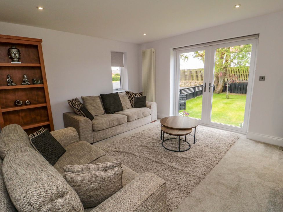 A living room with a sofa and coffee table at Wyvill House in Cayton