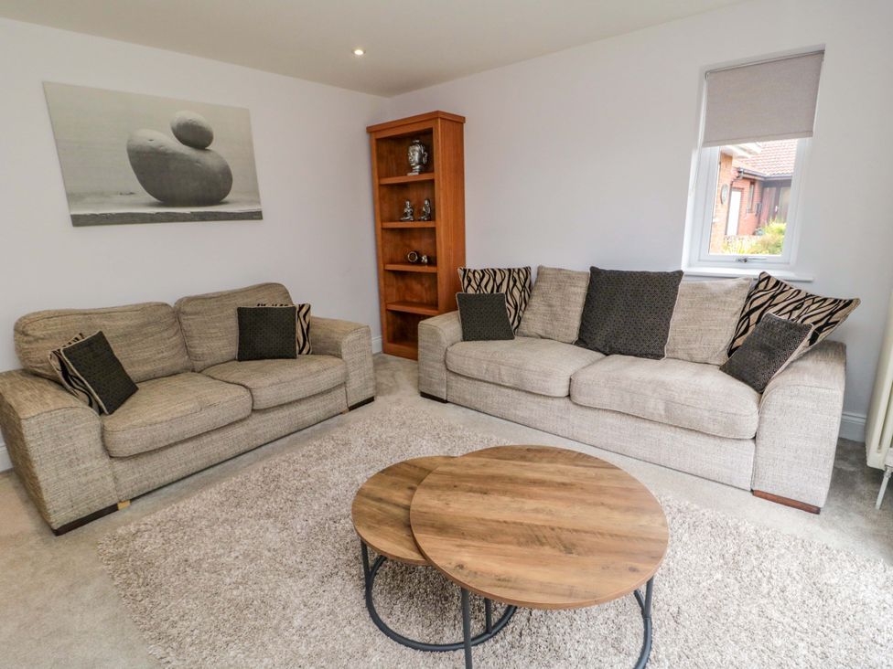 A living room with a sofa and coffee table at Wyvill House in Cayton