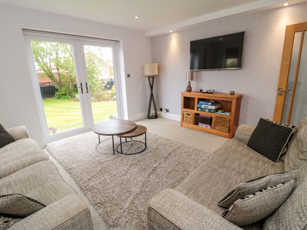 A living room with a coffee table and sofa at Wyvill House in Cayton